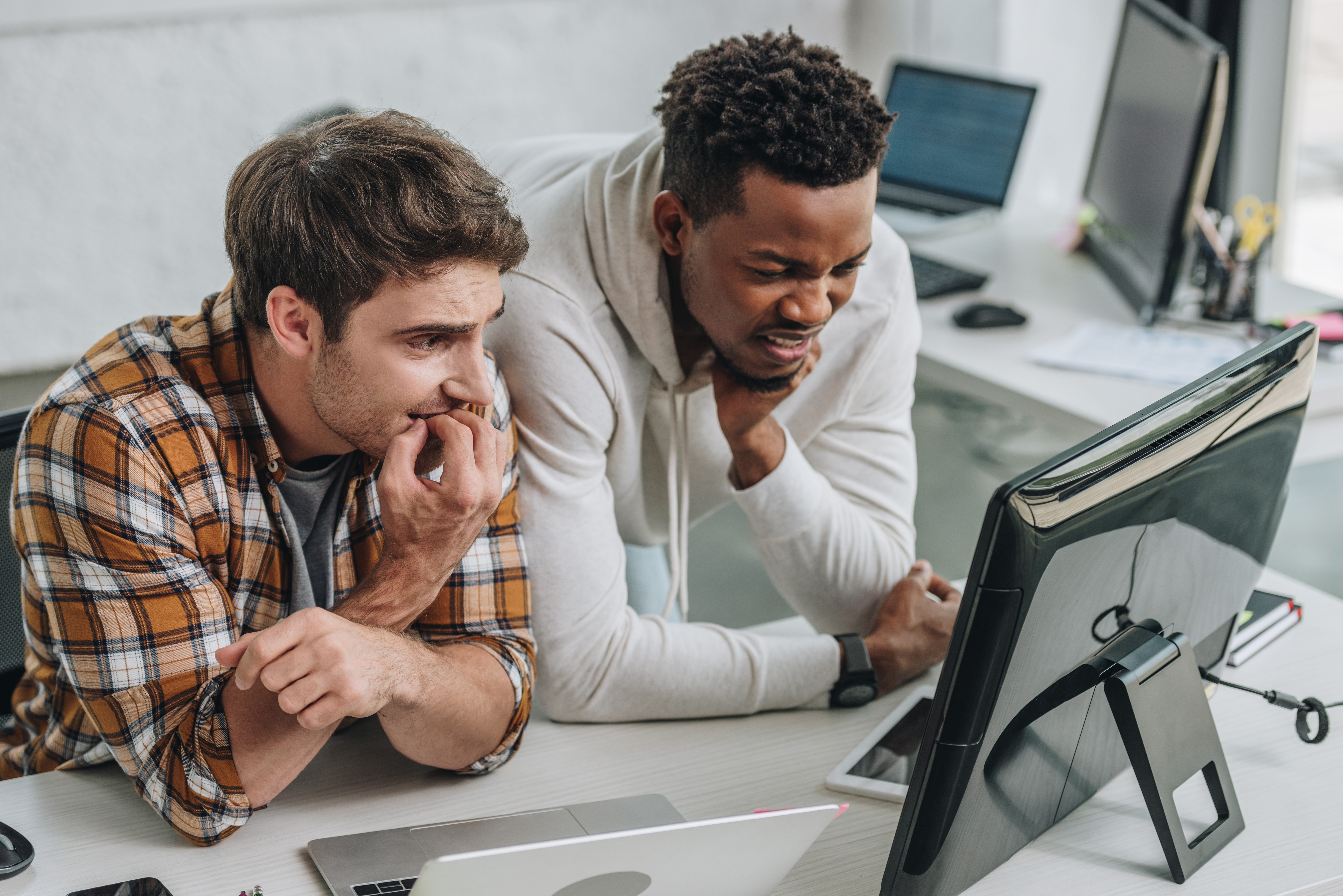 Two worried programmers looking at a screen